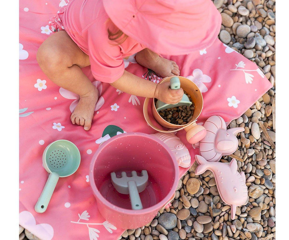 Set spiaggia in plastica bio, Monneka. Contiene 8 pezzi. In foto bambina che gioca con il set rosa